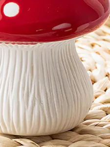 Detailed macro view showing the textured white stalk and glossy red cap of this mushroom resin vase