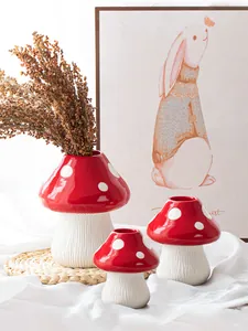 Group of red and white mushroom-shaped resin vases in different sizes for home decor