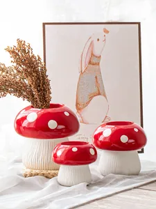 Detailed view of three creative red and white mushroom resin vases for home decoration