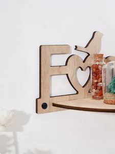 Detailed macro view of a Family wooden wall shelf showing heart cutout and wood grain.