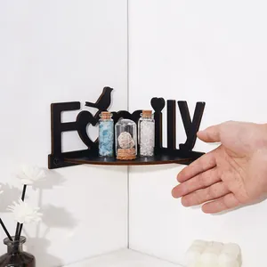 Detail view of Family letter wooden corner shelf with small decorative bottles for scale
