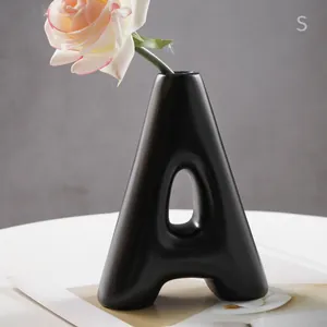Modern minimalist black resin A-shaped flower vase for high-end home and office decor