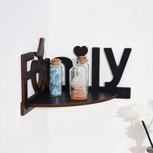 Close-up of black wooden corner shelf with creative Family letter design decoration