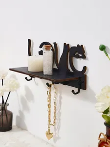 Close-up of black cat silhouette wall shelf with hooks for jewelry and candles