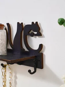 Macro close-up detail of creative black cat wall shelf with integrated storage and hooks