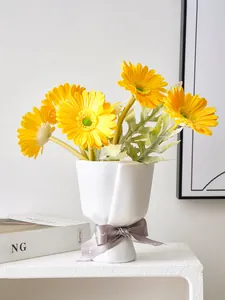Detailed view of the white bouquet-shaped resin vase with a ribbon bow decoration
