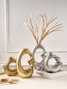 Nordic abstract spiral resin vases in gold and silver for stylish home decoration
