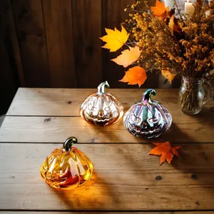 Exquisite handcrafted glass pumpkin ornaments with Jack-o'-lantern faces for Halloween decor