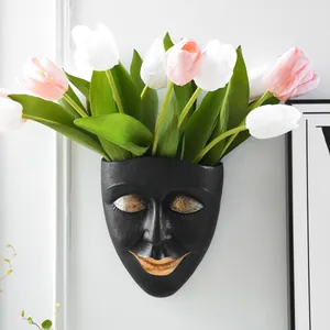 Artistic minimalist black resin human face wall planter for succulents and home decor