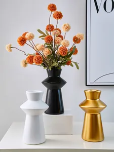 Modern Nordic lighthouse-shaped resin vases in black, white, and gold for home decor.