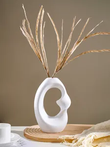 Close-up of a white Nordic abstract resin vase with a unique spiral hollow design