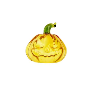 Minimalist amber glass pumpkin ornament with carved Jack-o'-lantern face for Halloween decor