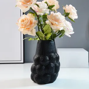 Moderner minimalistischer schwarzer Mesh-Blasenvase aus Harz mit rosa Rosen