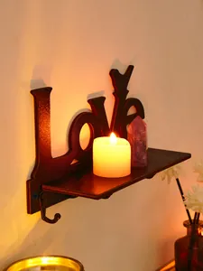 Close-up detail of Love bird wooden wall shelf with hooks and decorative candle setup.