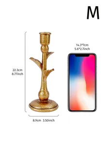 Vintage golden palm tree candlestick height 22.3cm with smartphone scale comparison