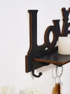 Close-up detail of a black wooden 'Love' wall shelf featuring a sturdy metal hook