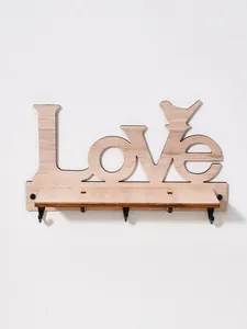 Detailed view of a wooden wall shelf with Love cutout and bird silhouette hooks