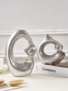 Modern abstract resin vases with silver metallic finish and spiral hollow design
