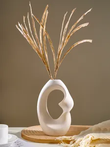 Detailed view of an abstract white resin vase with a unique oval cutout design