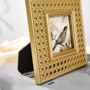 Close-up of a golden vintage resin photo frame featuring an intricate rattan texture