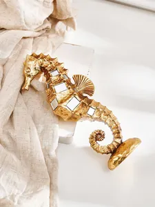 Detailed macro view of a golden resin seahorse sculpture with mirrored inlays