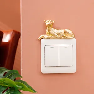 Detailed view of a golden resin leopard wall sticker decorating a light switch