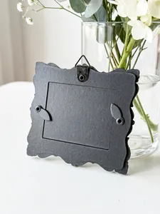 Detailed back view of a mini European retro black photo frame with hanging loop