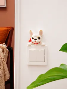 Detailed view of a cute French Bulldog resin switch sticker on a white home wall switch.