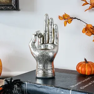 Detailed view of mystical silver resin palm candle holder with engraved patterns