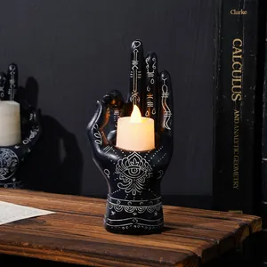 Detailed view of mystical black palmistry hand resin candlestick with LED candle light