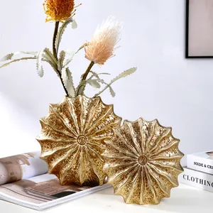 Golden seashell-shaped resin vases for modern home decor and floral arrangements