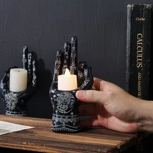 Close-up of retro mystical resin palm candle holder with intricate celestial sun and moon patterns