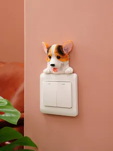 Detailed 3D Corgi resin wall sticker decorating a white household light switch on a pink wall.