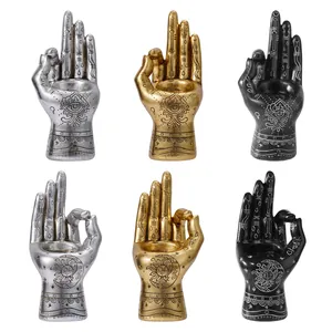 Mystical resin palm candle holders in gold, silver, and black with esoteric engravings