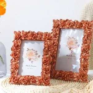 Detailed view of two vintage bronze rose resin photo frames in 3.5x5 and 4x6 sizes.