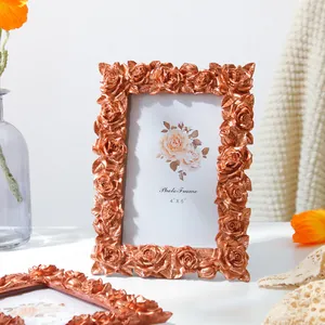 Detailed view of vintage copper resin photo frame with 3D rose carvings