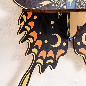 Wooden butterfly wall shelf detail, laser cut wood wall decor with moon and leaf print.