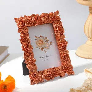 Detailed view of a vintage rose gold resin photo frame with ornate 3D rose carvings