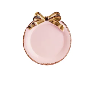 Elegante bandeja de joyería de cerámica rosa con lazo dorado para anillos y pendientes