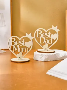 Detail view of laser-cut wooden heart ornaments with Best Mum and Best Dad lettering