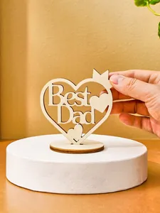 Close-up of a laser-cut wooden heart ornament with Best Dad cutout for Father's Day