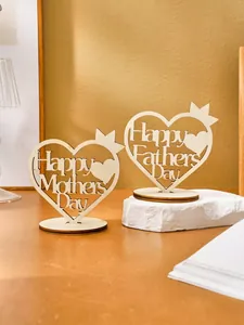 Close-up of heart-shaped wooden ornaments with Happy Mother's and Father's Day cutout text.