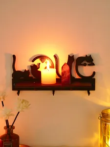 Decorative black cat wall shelf with hooks and 'LOVE' cutout design in warm light