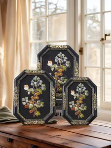 Detailed view of three vintage octagonal resin photo frames with gold embossed floral borders