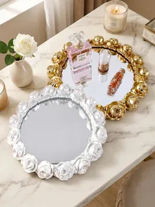 Detail of vintage European rose embossed round trays in gold and pearl white finishes