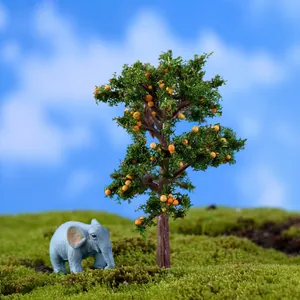 Miniature landscape scene with a detailed fruit tree and a small elephant figurine