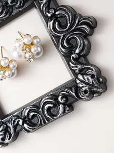 Close-up of European vintage black and silver resin frame with ornate floral relief
