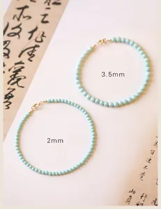 Comparison view of 2mm and 3.5mm natural turquoise bead bracelets featuring 14k gold clasps