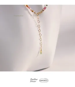 Close-up detail showing the 14K gold filled heart shaped extension chain on a tourmaline necklace