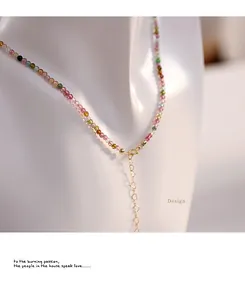 Detail of natural tourmaline bead necklace with 14K gold filled heart extender chain